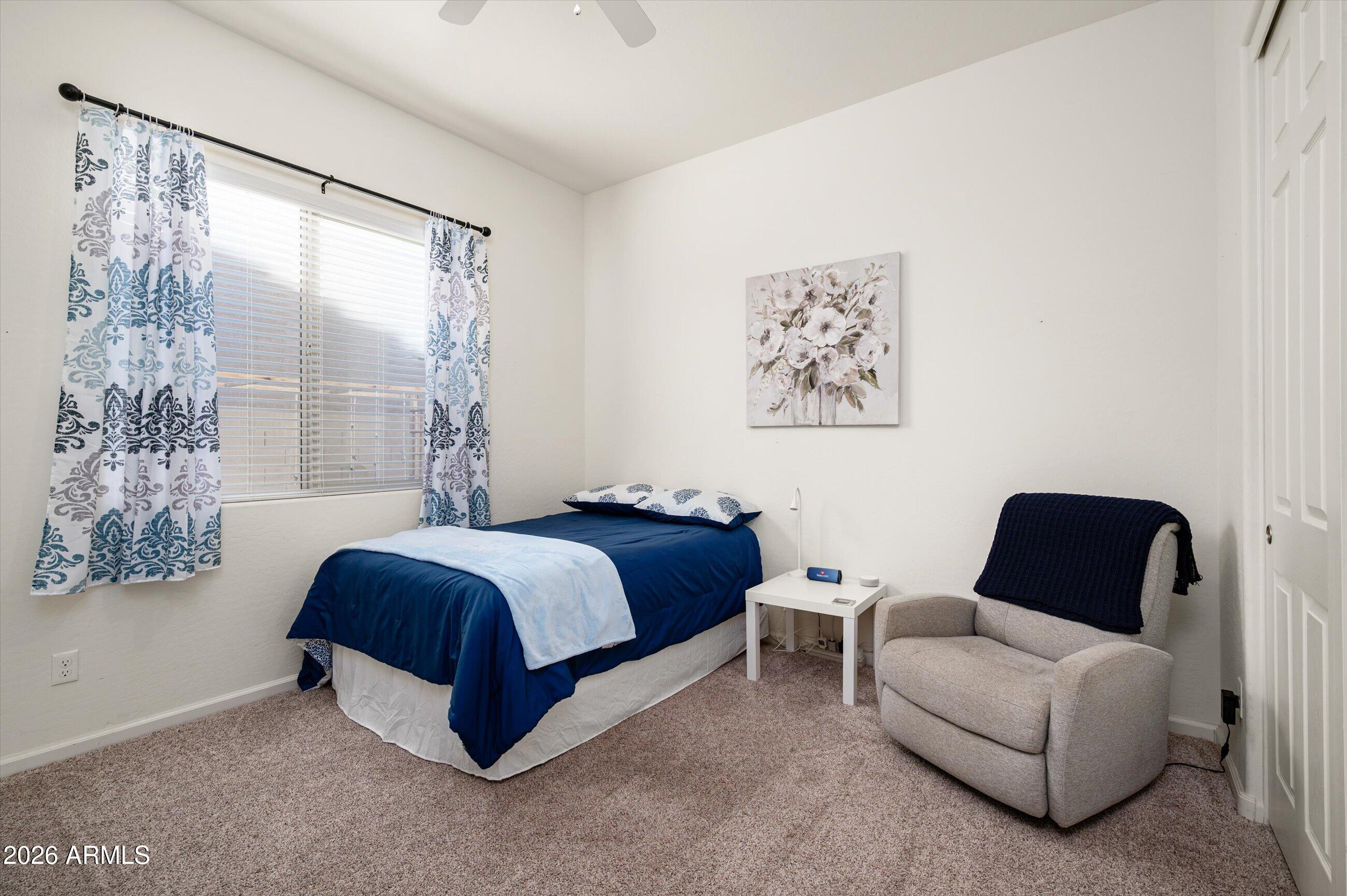 6406 Copper Springs Road Phoenix, AZ 85083 - Photo 32 of 59 a spacious bedroom with a bed and a couch next to a window