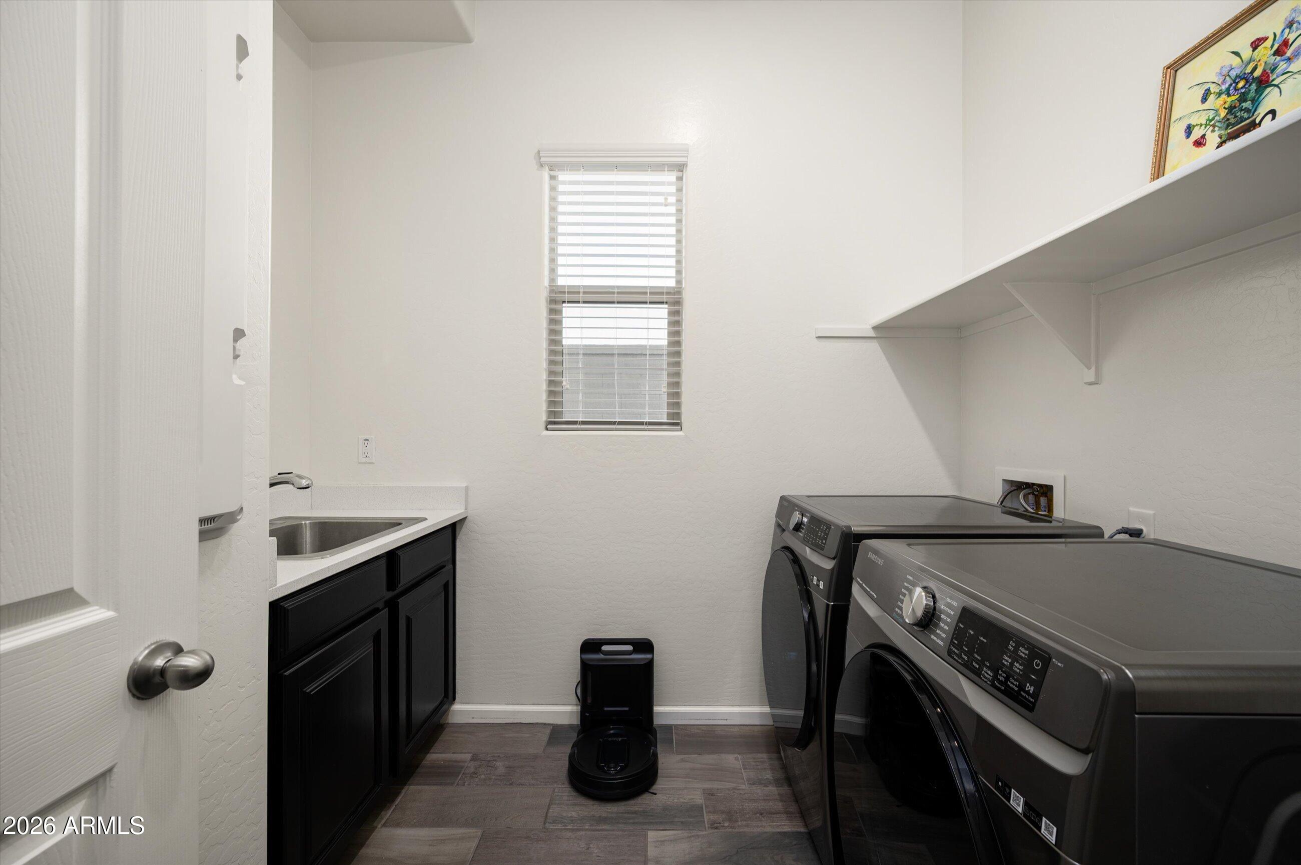 6406 Copper Springs Road Phoenix, AZ 85083 - Photo 33 of 59 a utility room with a sink dryer and washer