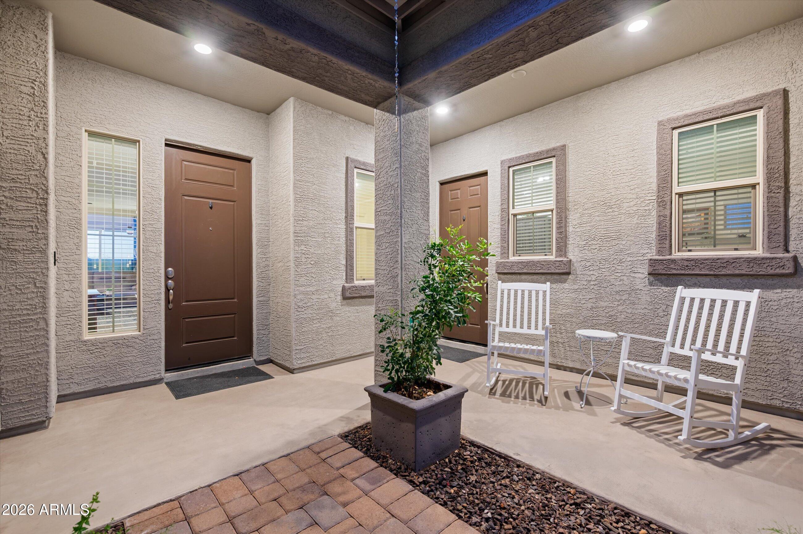 6406 Copper Springs Road Phoenix, AZ 85083 - Photo 6 of 59 a view of a porch with chairs and potted plants