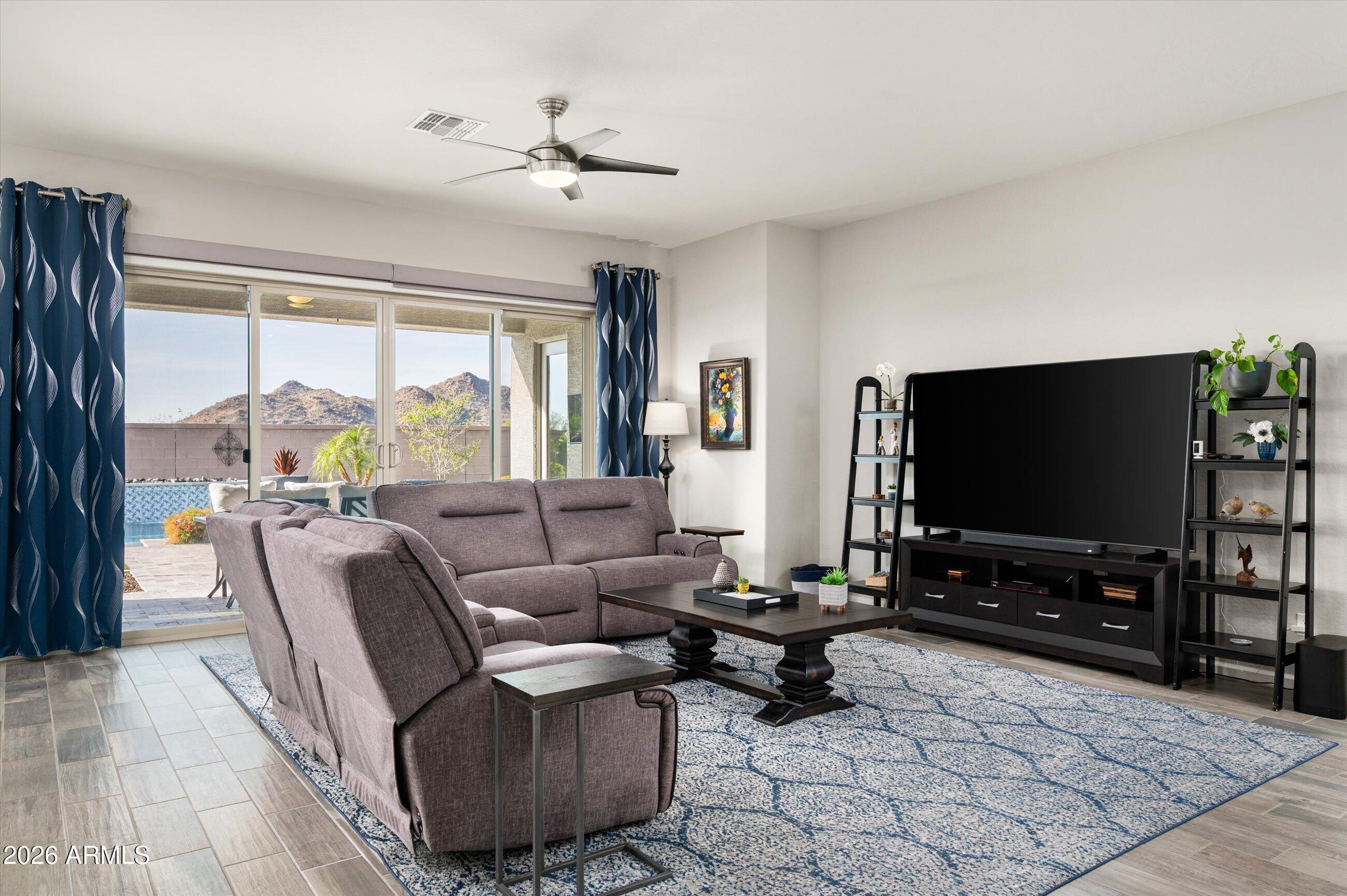 6406 Copper Springs Road Phoenix, AZ 85083 - Photo 9 of 59 a living room with furniture and a flat screen tv