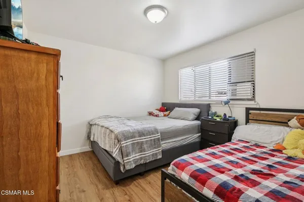 a bedroom with two beds and a window