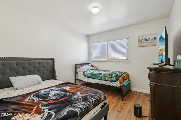 a bedroom with bed and a couch