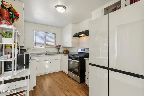 a kitchen with a stove a sink and a refrigerator