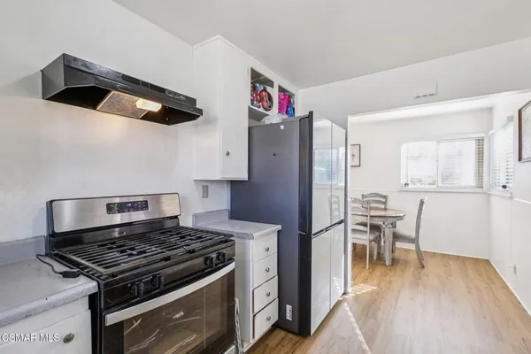 a kitchen with stainless steel appliances granite countertop a stove and a refrigerator