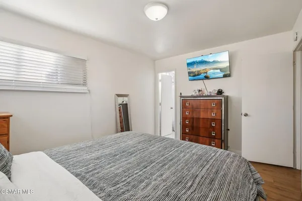 a bedroom with a bed and a dresser