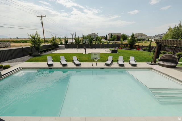 924 Country Lane Farmington, UT 84025 - Photo 67 of 91 Outdoor swimming pool with integrated sun shelf and steps, surrounded by concrete decking