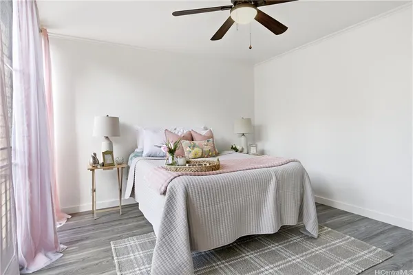 a bedroom with a bed and a chandelier