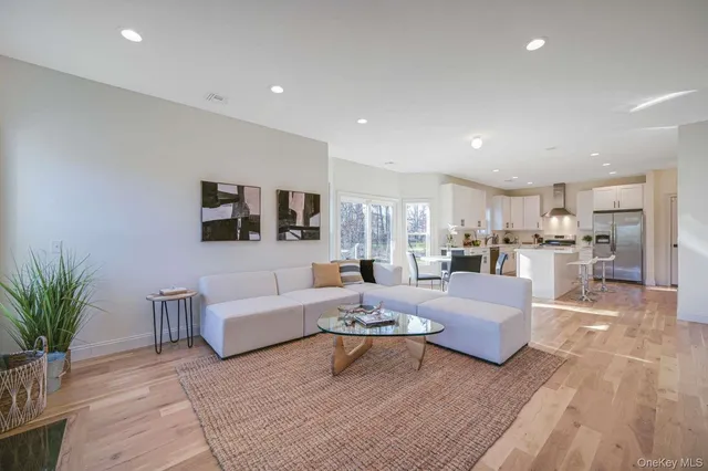 a living room with furniture and view of kitchen