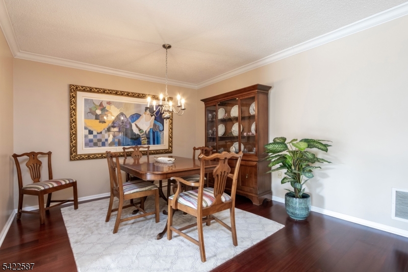 504 Reading Circle Bridgewater, NJ 08807 - Photo 11 of 35 a dining room with furniture potted plants and wooden floor