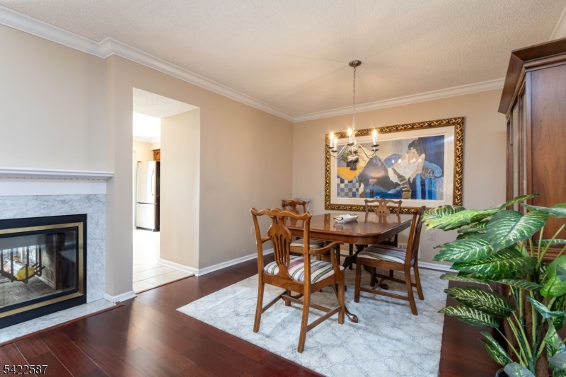 504 Reading Circle Bridgewater, NJ 08807 - Photo 12 of 35 a dining room with furniture a fireplace and wooden floor