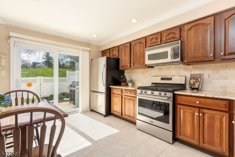 504 Reading Circle Bridgewater, NJ 08807 - Photo 13 of 35 a kitchen with stainless steel appliances granite countertop a stove a sink and a refrigerator