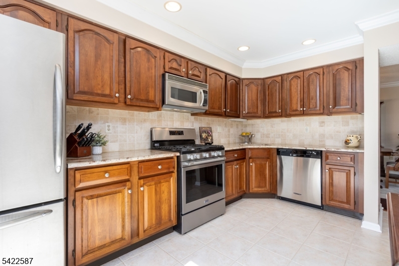 504 Reading Circle Bridgewater, NJ 08807 - Photo 14 of 35 a kitchen with stainless steel appliances granite countertop a stove sink and cabinets