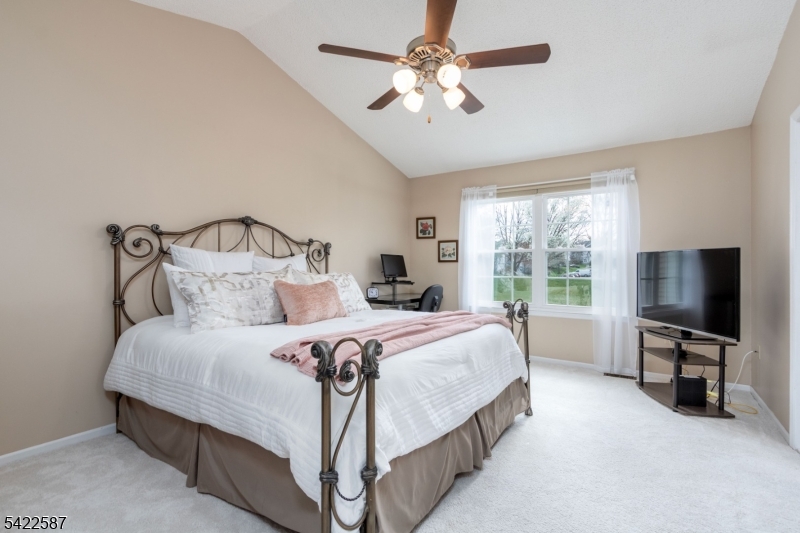 504 Reading Circle Bridgewater, NJ 08807 - Photo 20 of 35 a bedroom with a bed flat screen tv and a large window