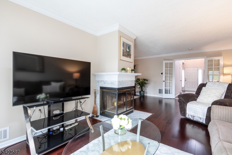 504 Reading Circle Bridgewater, NJ 08807 - Photo 10 of 35 a living room with furniture a flat screen tv and a fireplace
