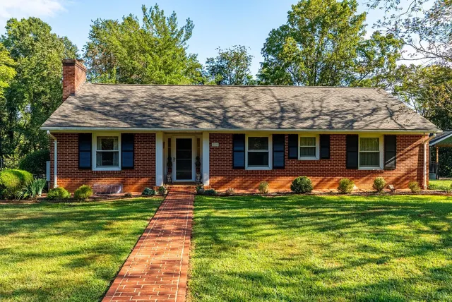 a front view of a house with a yard and porch