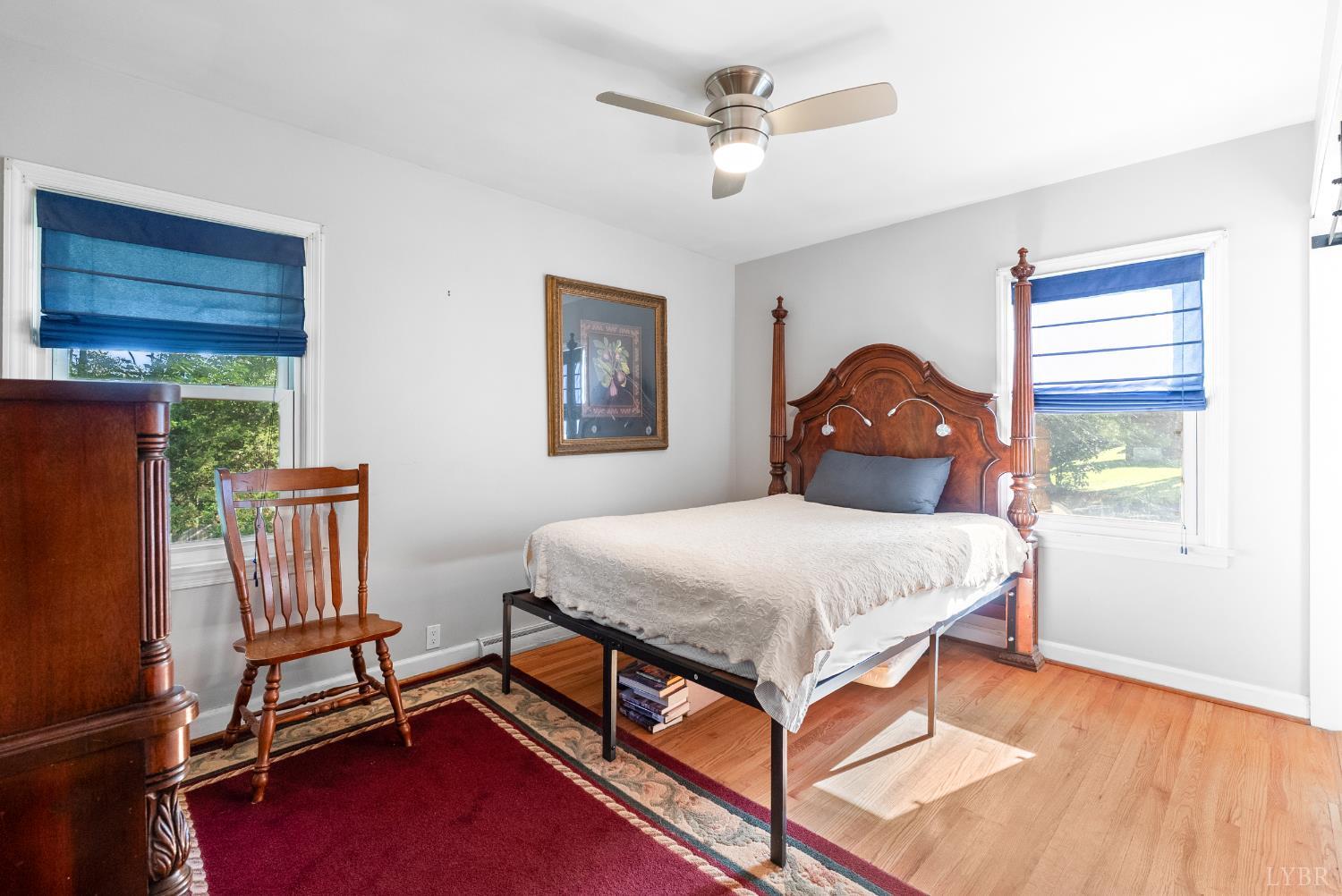 224 Sunset Drive Amherst, VA 24521 - Photo 18 of 34 a bedroom with a bed and a chandelier