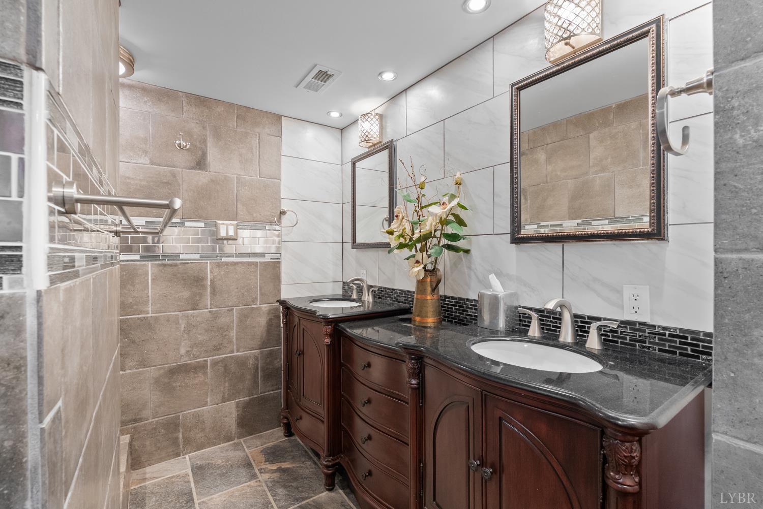224 Sunset Drive Amherst, VA 24521 - Photo 25 of 34 a bathroom with a granite countertop sink a mirror and a shower