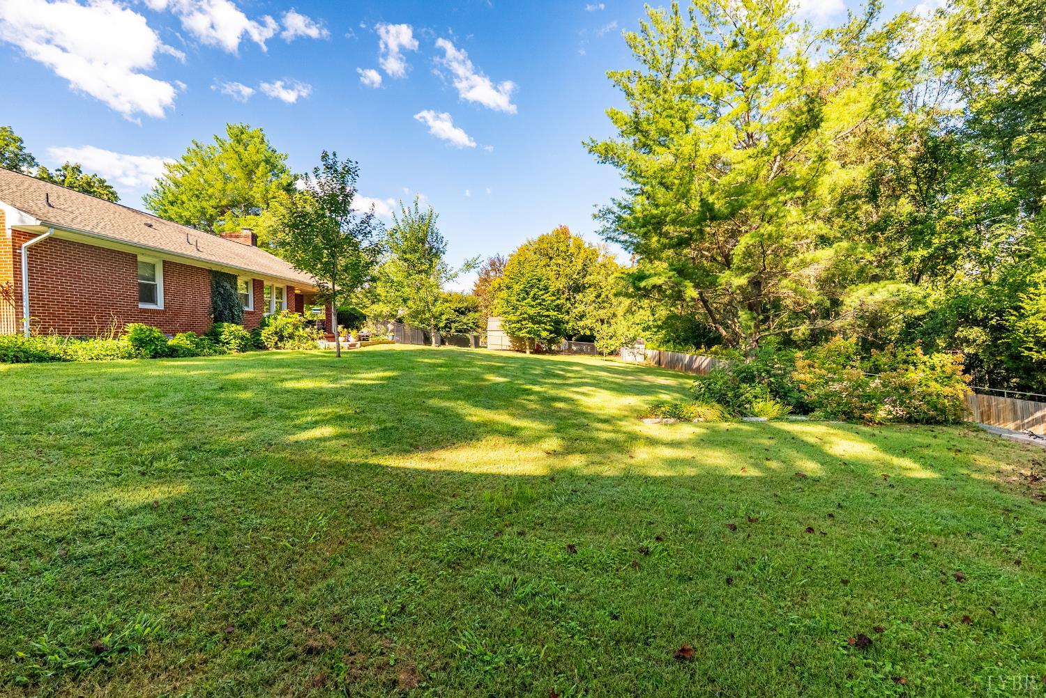 224 Sunset Drive Amherst, VA 24521 - Photo 32 of 34 a backyard of a house with lots of green space and garden