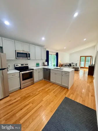 a large kitchen with cabinets and stainless steel appliances