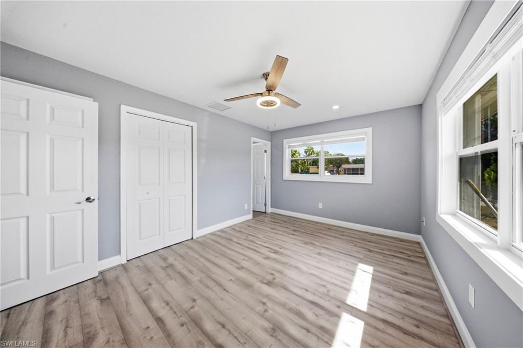 4375 Golden Gate Parkway Naples, FL 34116 - Photo 13 of 34 Unfurnished bedroom featuring light wood-style flooring, a ceiling fan, and a closet