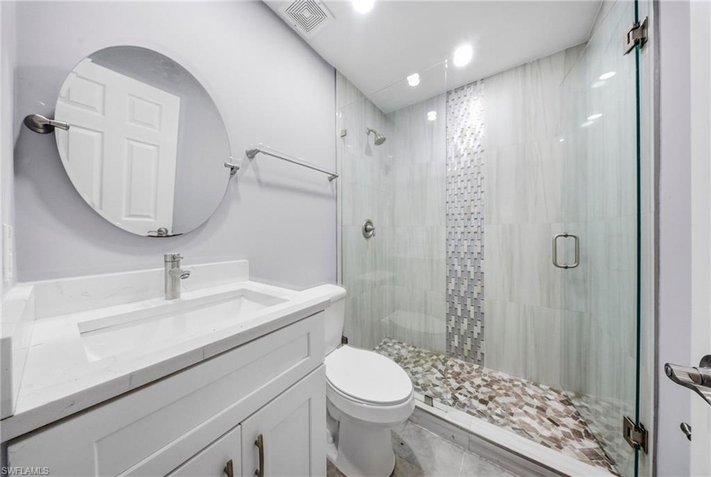4375 Golden Gate Parkway Naples, FL 34116 - Photo 16 of 34 Bathroom with vanity, a stall shower, and recessed lighting