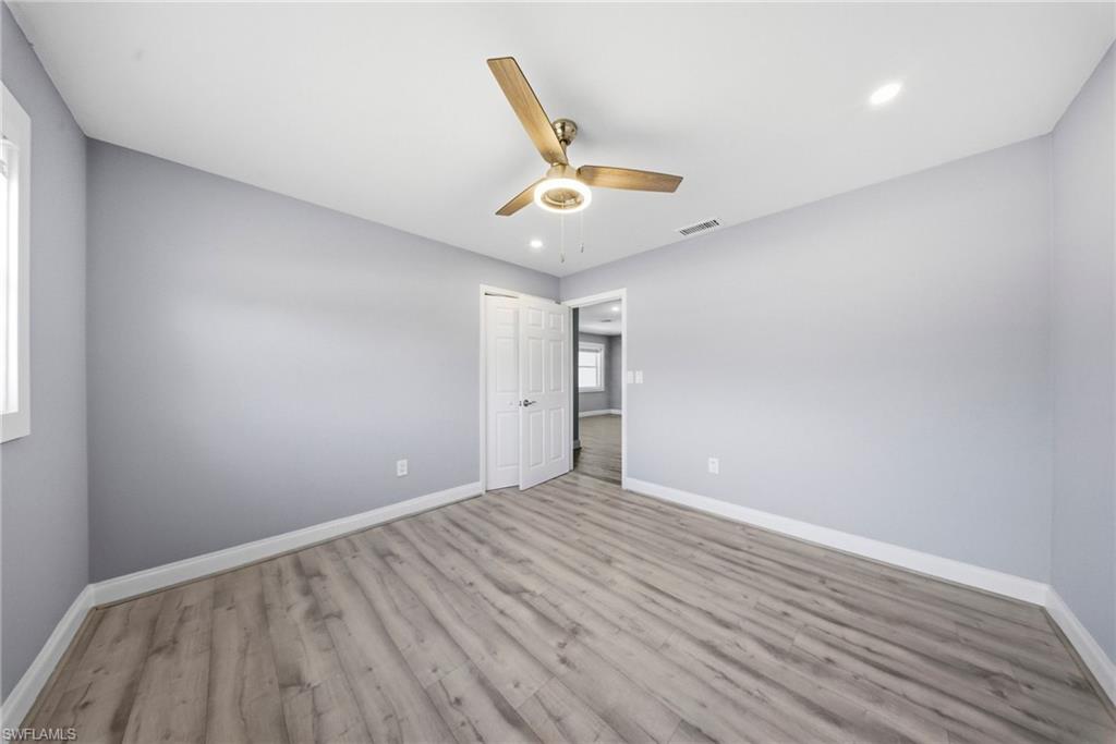 4375 Golden Gate Parkway Naples, FL 34116 - Photo 18 of 34 Unfurnished bedroom with wood finished floors, a ceiling fan, and recessed lighting