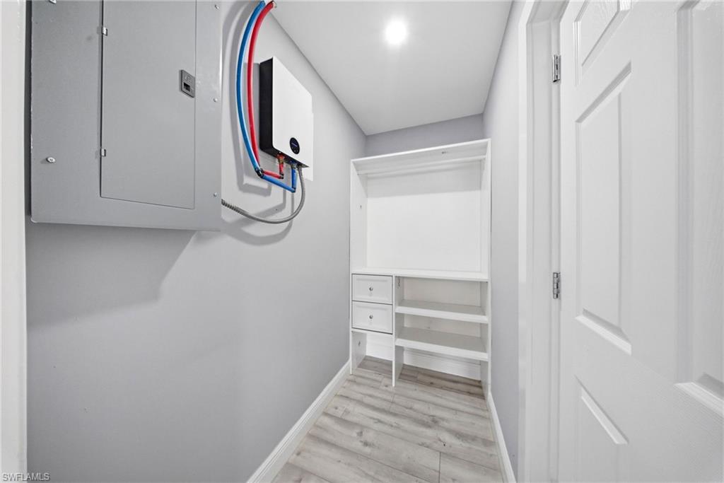 4375 Golden Gate Parkway Naples, FL 34116 - Photo 23 of 34 Walk in closet with electric panel and light wood-type flooring
