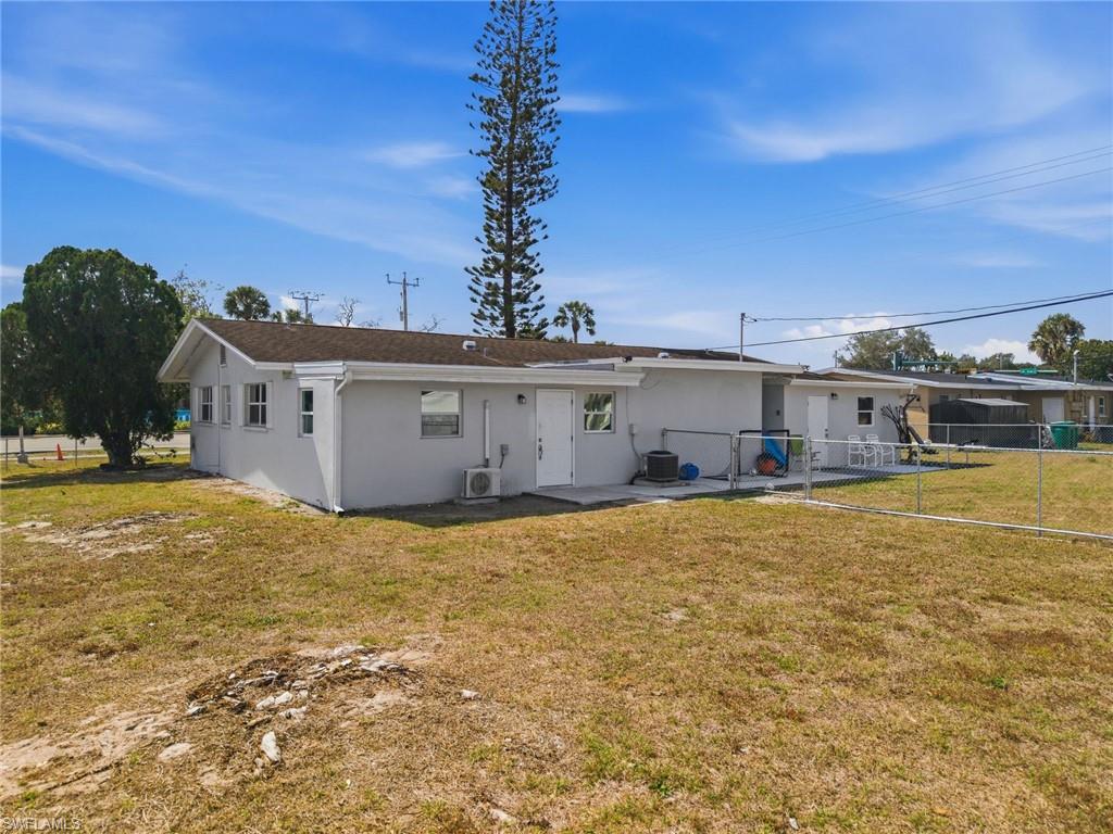 4375 Golden Gate Parkway Naples, FL 34116 - Photo 29 of 34 Rear view of house with stucco siding and a patio