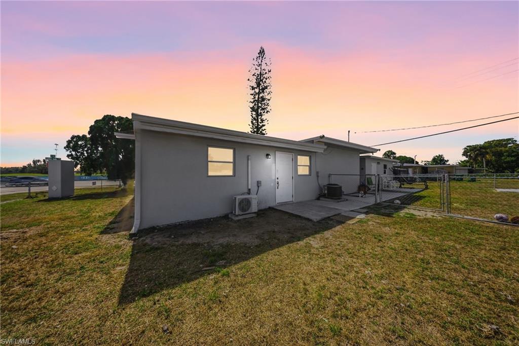 4375 Golden Gate Parkway Naples, FL 34116 - Photo 31 of 34 Back of house with a gate, stucco siding, and a patio