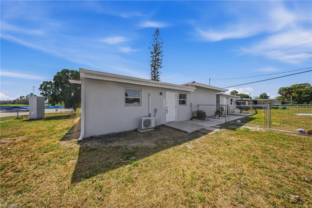 4375 Golden Gate Parkway Naples, FL 34116 - Photo 33 of 34 Rear view of property featuring a gate, stucco siding, and a patio area
