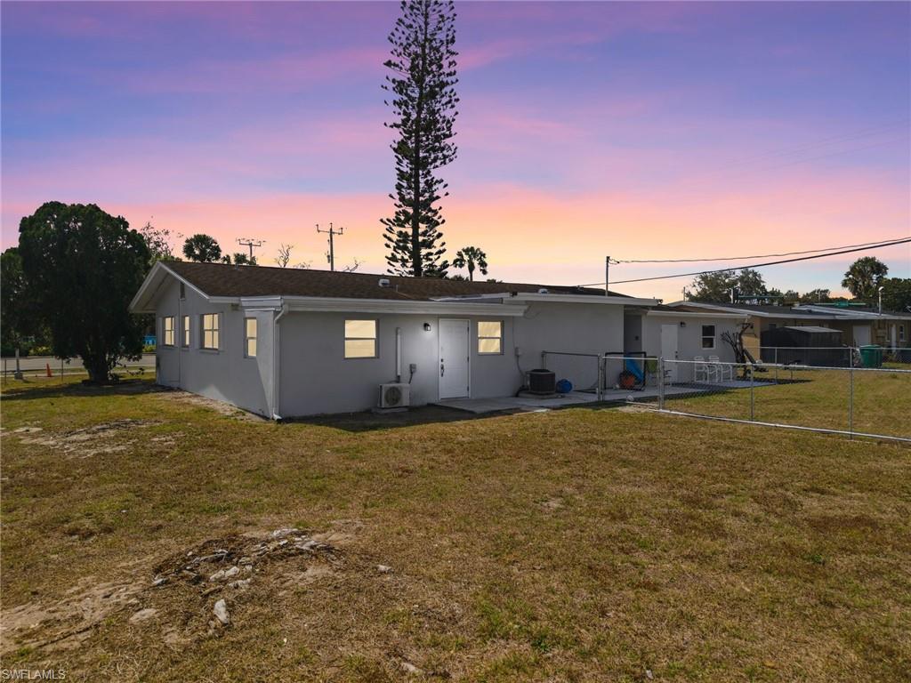 4375 Golden Gate Parkway Naples, FL 34116 - Photo 5 of 34 Back of property at dusk with stucco siding and a patio area