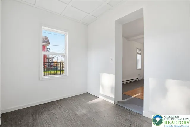 an empty room with windows and closet