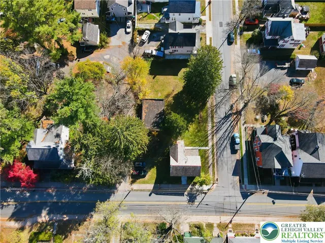 an aerial view of a house with swimming pool and garden view