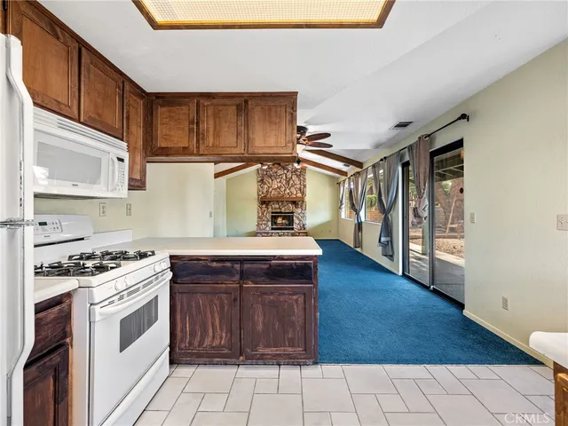 a kitchen with stainless steel appliances granite countertop a stove a sink dishwasher and a refrigerator