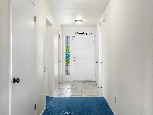 a view of hallway with wooden floor