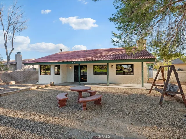 a front view of a house with a yard and seating space