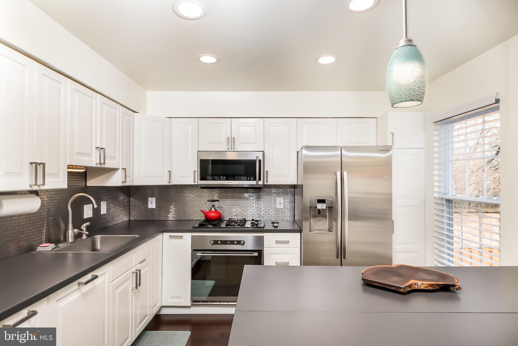 6401 Racetec Court Springfield, VA 22150 - Photo 9 of 29 Renovated, light-filled kitchen with SS appliances