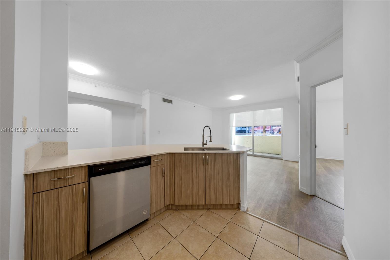 9172 Collins Avenue, Unit 212 Surfside, FL 33154 - Photo 16 of 31 a kitchen with a sink cabinets and window