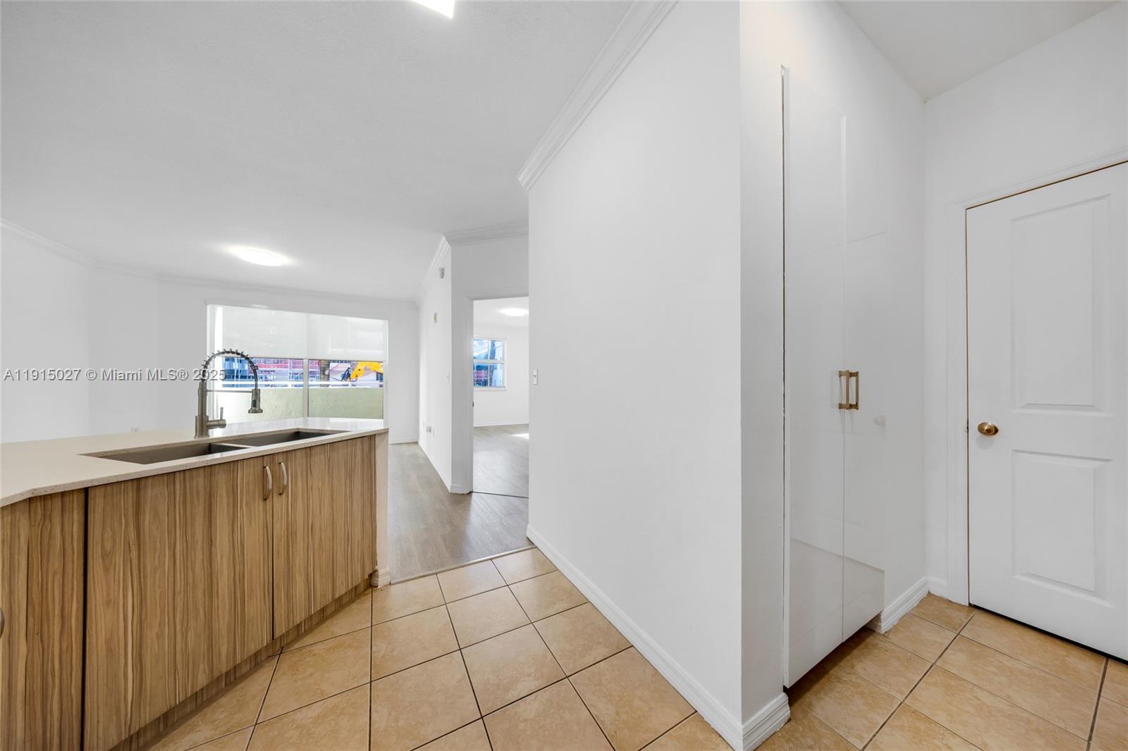 9172 Collins Avenue, Unit 212 Surfside, FL 33154 - Photo 21 of 31 a kitchen with stainless steel appliances a refrigerator and a sink