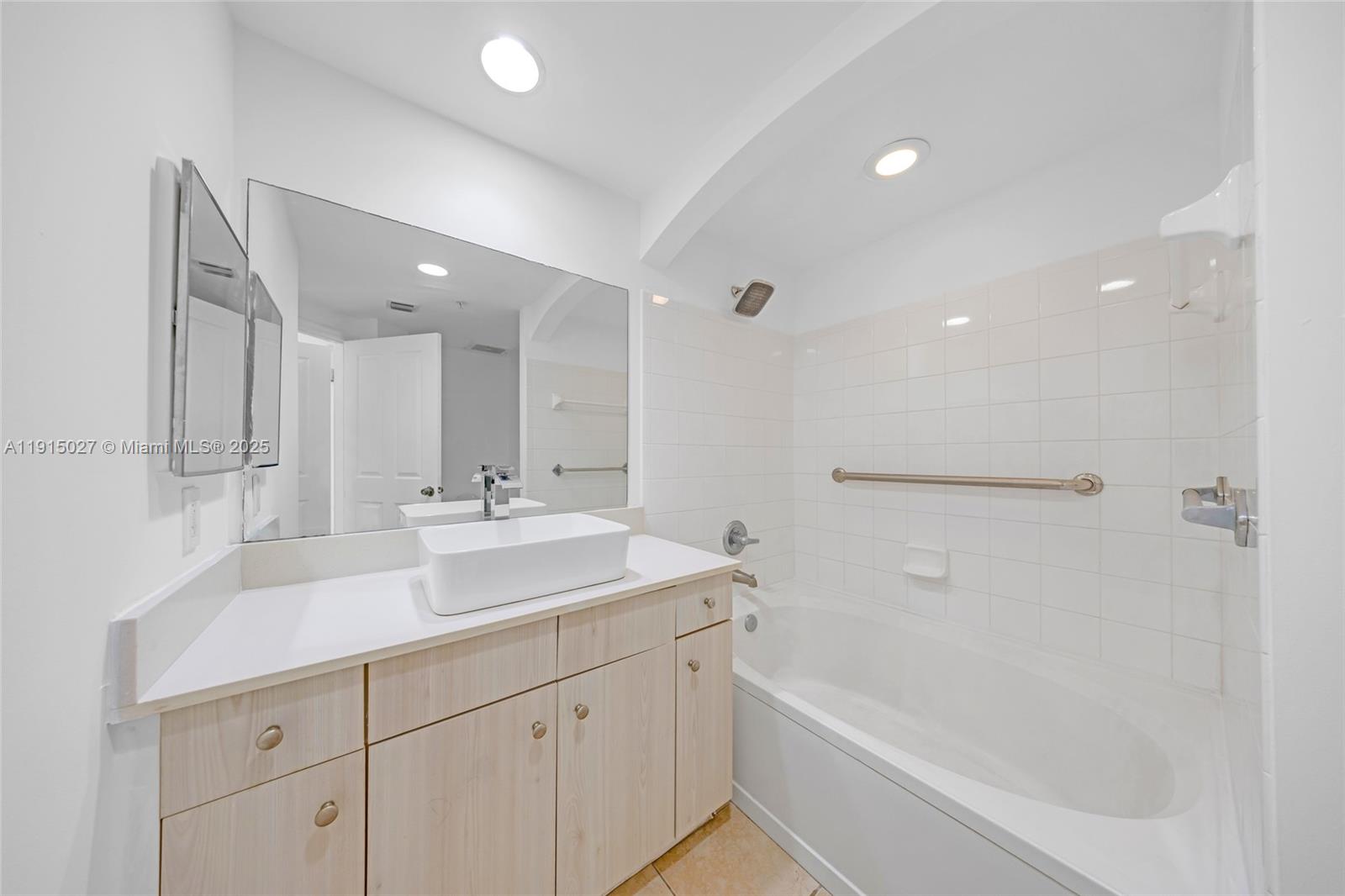 9172 Collins Avenue, Unit 212 Surfside, FL 33154 - Photo 6 of 31 a bathroom with a sink double vanity granite tub shower and a mirror