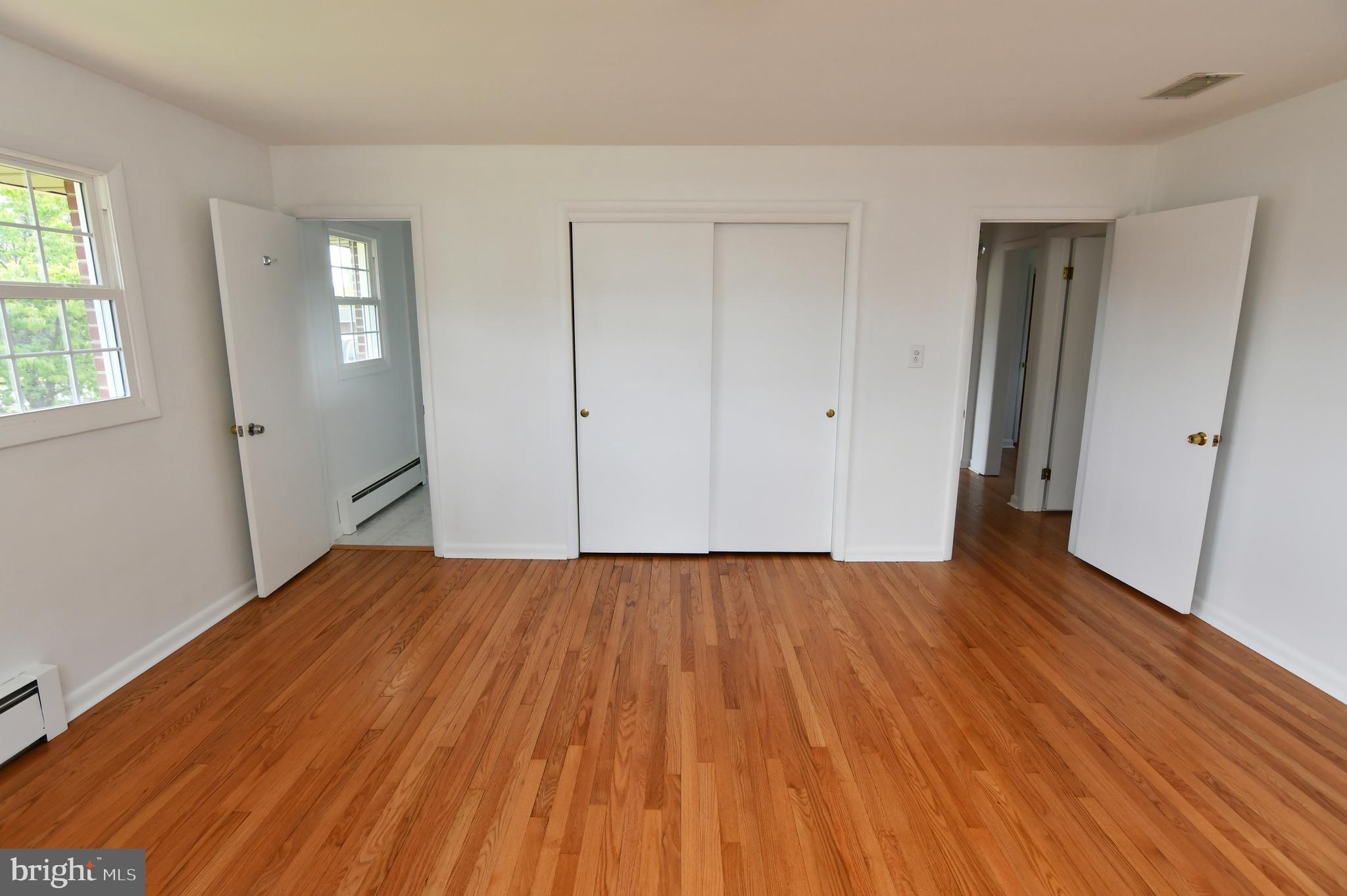 437 Beechcroft Road Winchester, VA 22601 - Photo 25 of 52 a view of an empty room with wooden floor and a window