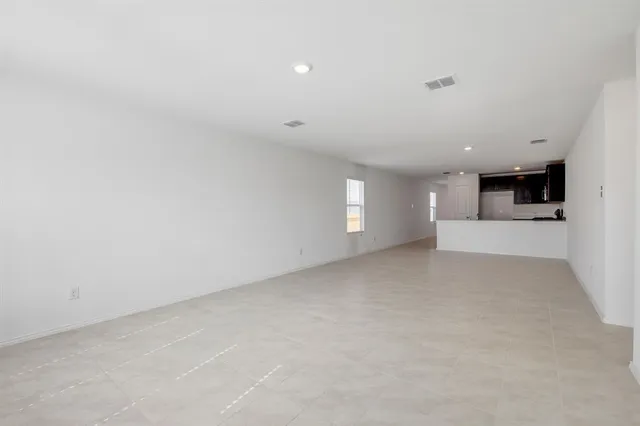 a view of a big room with windows and fireplace