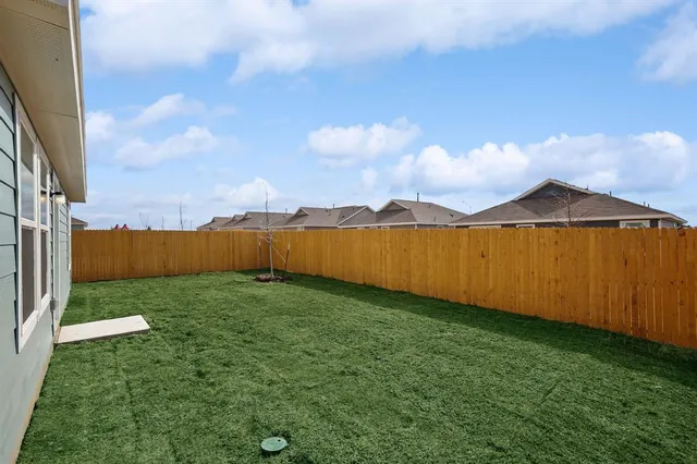 a view of a street with a big yard