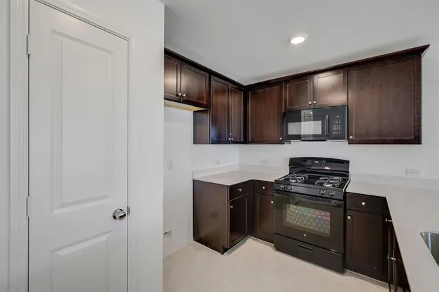 a kitchen with stainless steel appliances a stove a microwave and cabinets