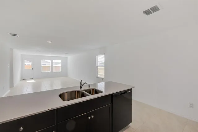 a kitchen with a sink cabinets and window