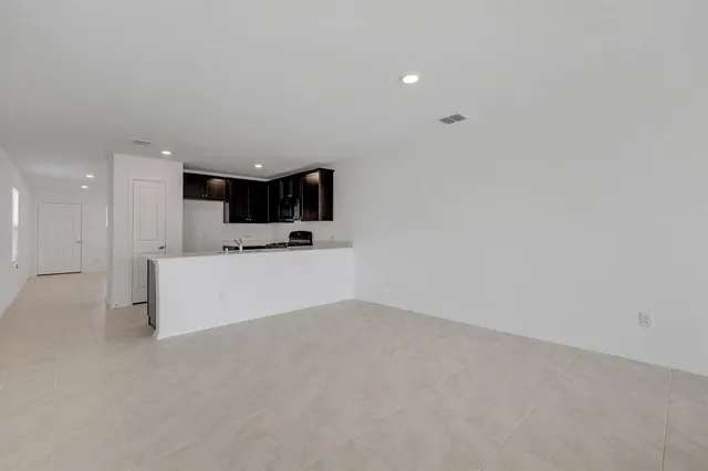 a view of a kitchen with a sink and white cabinets