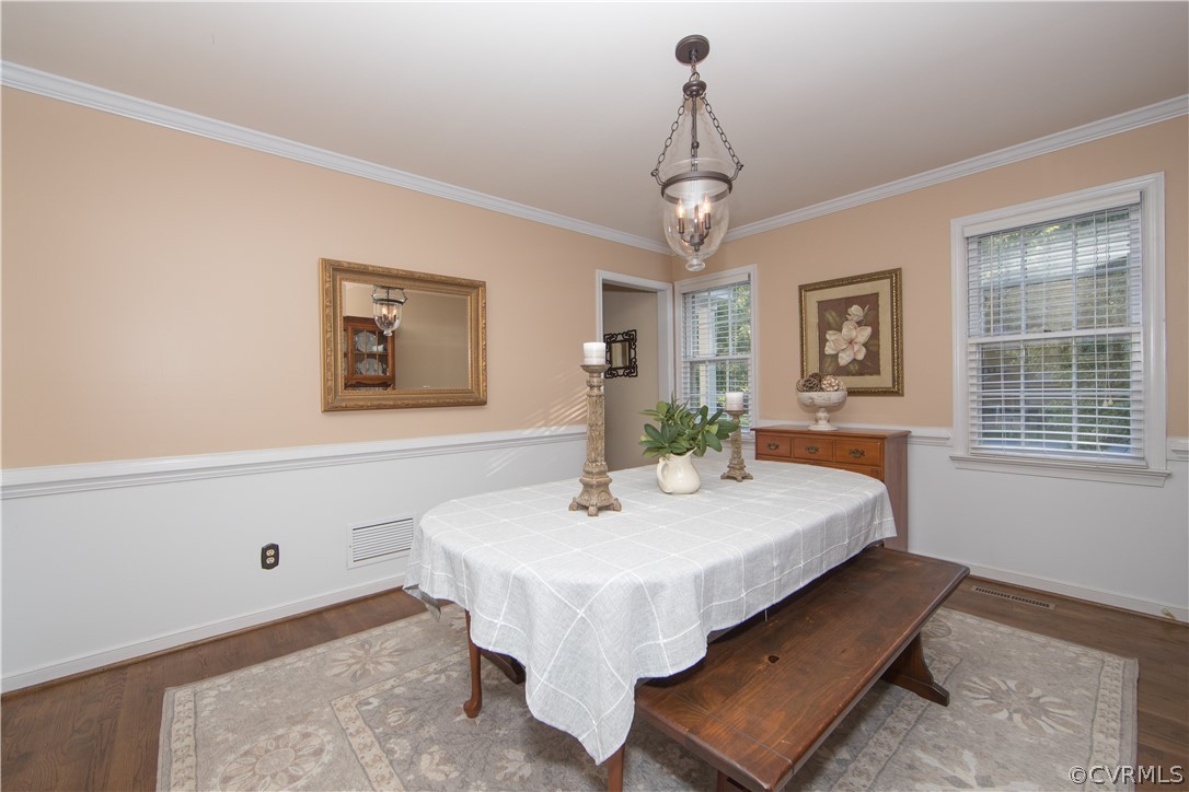 807 Dawnwood Road Midlothian, VA 23114 - Photo 12 of 37 a dining room with wooden floor and chandelier