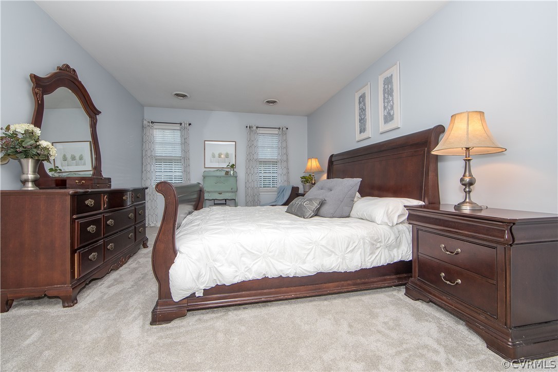 807 Dawnwood Road Midlothian, VA 23114 - Photo 16 of 37 a bedroom with a bed and a lamp on dresser