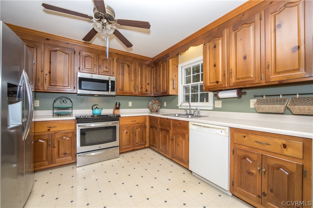 807 Dawnwood Road Midlothian, VA 23114 - Photo 10 of 37 a kitchen with stainless steel appliances granite countertop a sink a stove a refrigerator cabinets and a window
