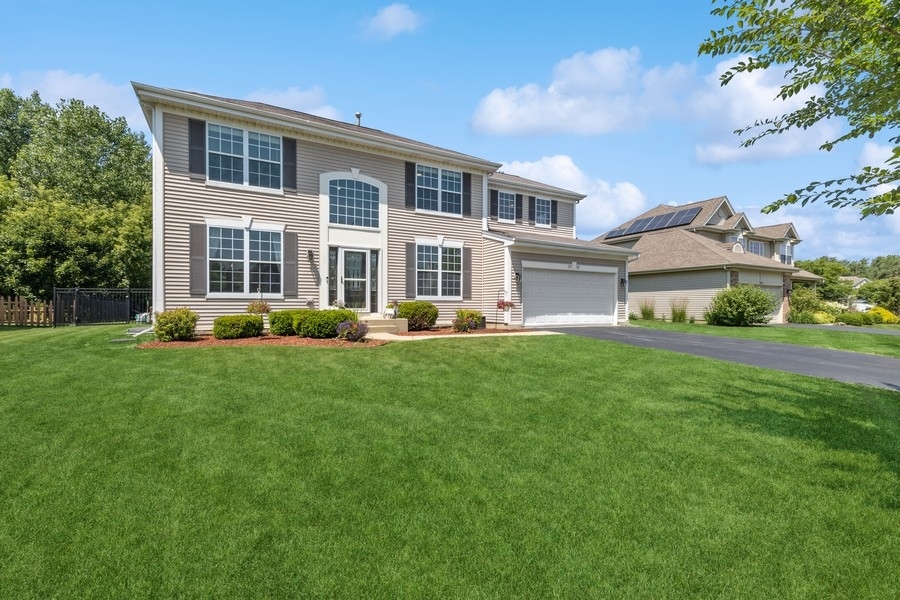 a front view of house with yard and green space